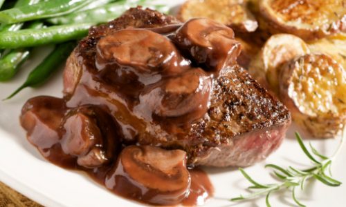 "Juicy steak with a ruby port wine mushroom sauce, roasted potatoes, and green beans."